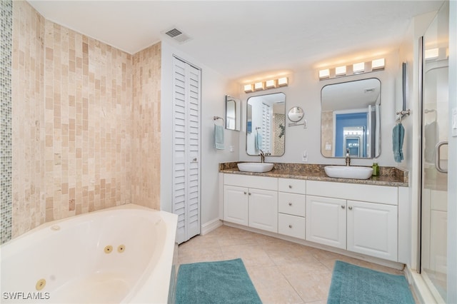 bathroom featuring tile walls, tile patterned flooring, vanity, and plus walk in shower