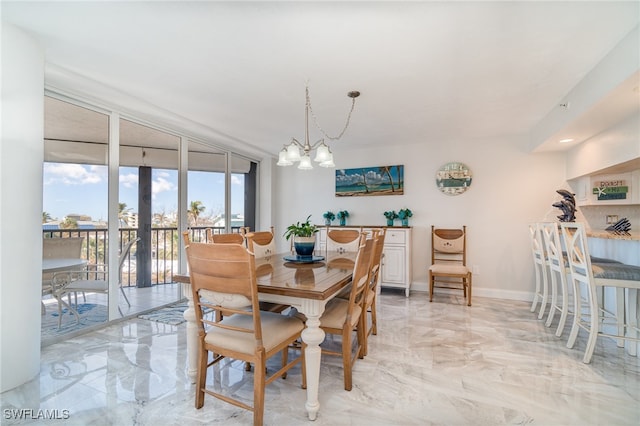 dining area with a chandelier, french doors, and floor to ceiling windows