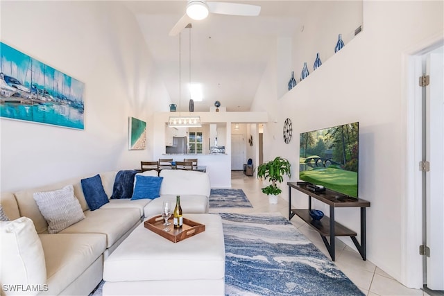 tiled living room featuring high vaulted ceiling and ceiling fan