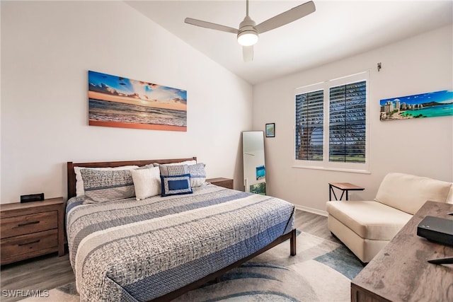 bedroom featuring ceiling fan, vaulted ceiling, and hardwood / wood-style floors