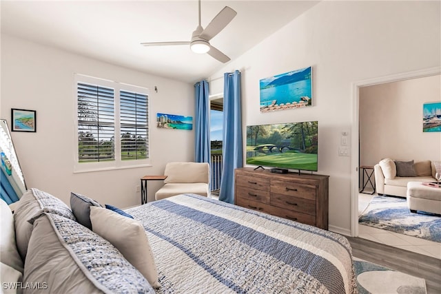 bedroom with ceiling fan, wood-type flooring, and lofted ceiling