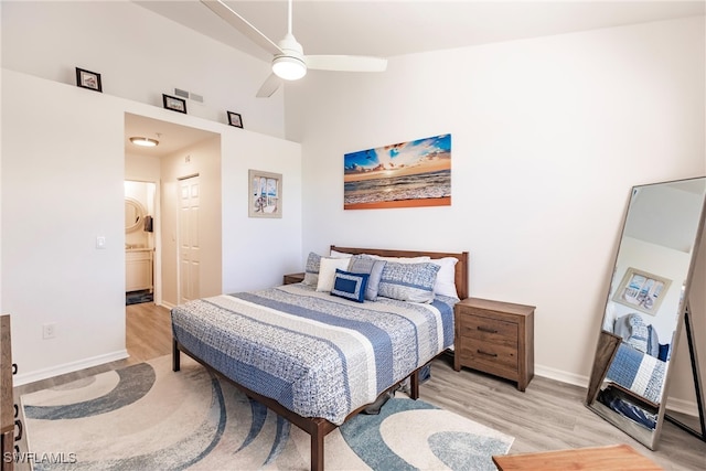 bedroom with light hardwood / wood-style floors, ensuite bath, and ceiling fan