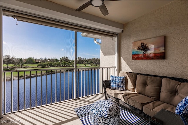 sunroom / solarium featuring a water view and ceiling fan