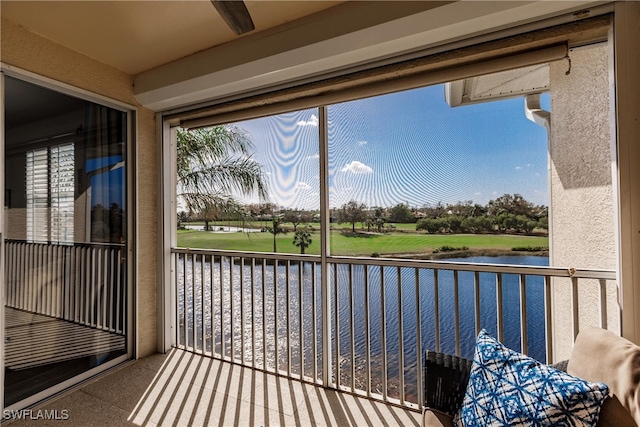 unfurnished sunroom featuring a water view