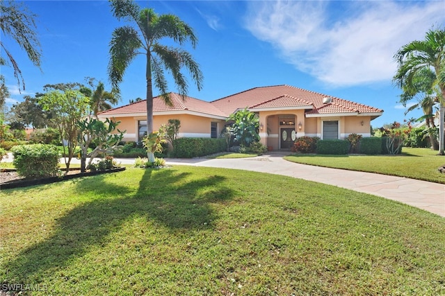 4632 Shearwater Ln, Naples, FL 34119 - mediterranean / spanish house featuring stucco siding, a tile roof, and a front lawn