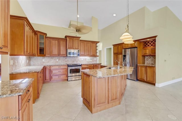 4632 Shearwater Ln, Naples, FL 34119 - kitchen with appliances with stainless steel finishes, a sink, high vaulted ceiling, light tile patterned floors, and backsplash