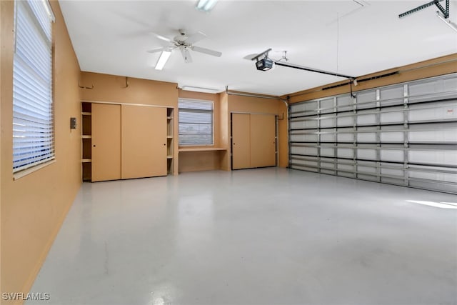 garage with a garage door opener and ceiling fan