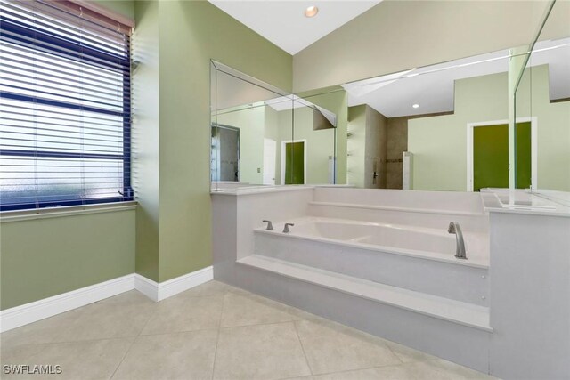 4632 Shearwater Ln, Naples, FL 34119 - bathroom with lofted ceiling, a shower stall, tile patterned floors, baseboards, and a garden tub