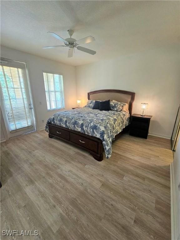 bedroom featuring baseboards, ceiling fan, and wood finished floors