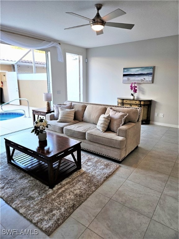 tiled living room with ceiling fan