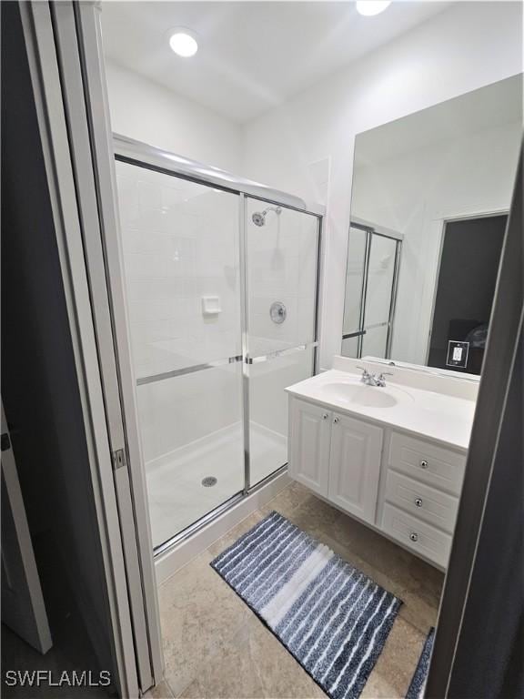 bathroom with vanity and a shower stall