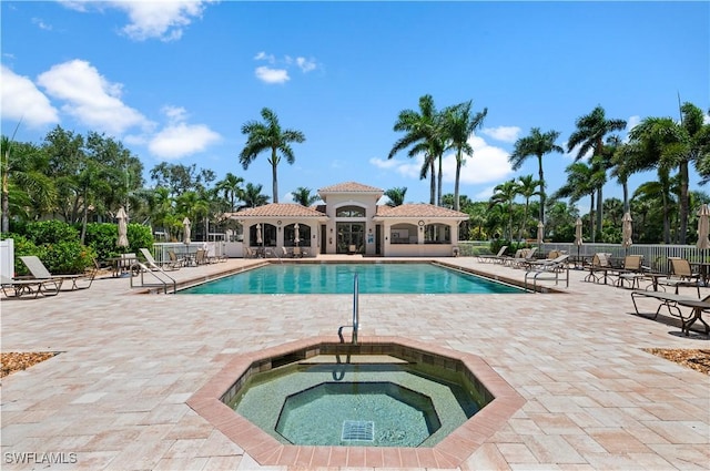 view of pool featuring a hot tub and a patio