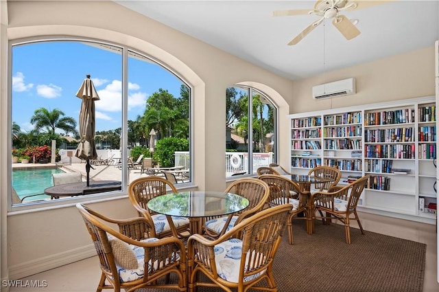 dining space with ceiling fan and an AC wall unit