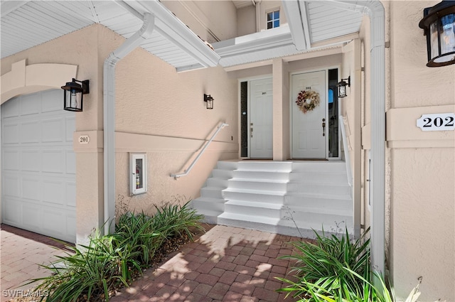 doorway to property with a garage