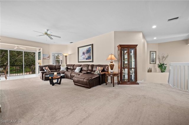 carpeted living room with ceiling fan