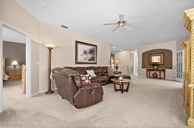 carpeted living room with ceiling fan