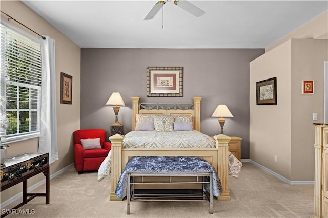 carpeted bedroom with ceiling fan and multiple windows