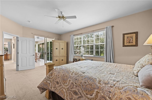 bedroom featuring light carpet, ceiling fan, and access to exterior