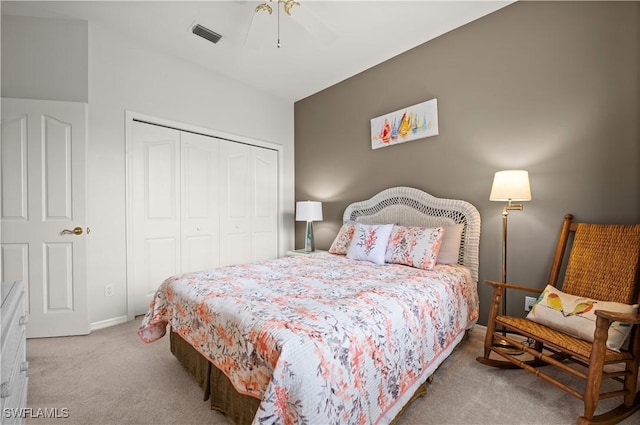 carpeted bedroom with ceiling fan and a closet