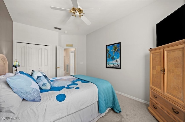 carpeted bedroom featuring ceiling fan and a closet