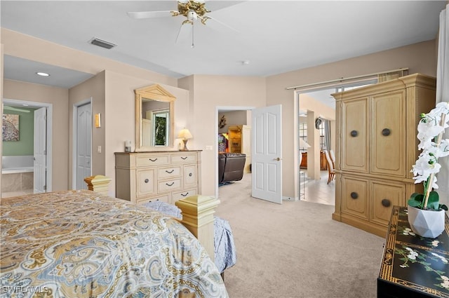 carpeted bedroom featuring ceiling fan and ensuite bathroom