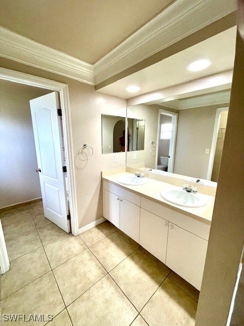 bathroom with vanity, crown molding, tile patterned floors, and toilet