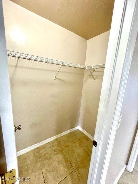 walk in closet with tile patterned floors