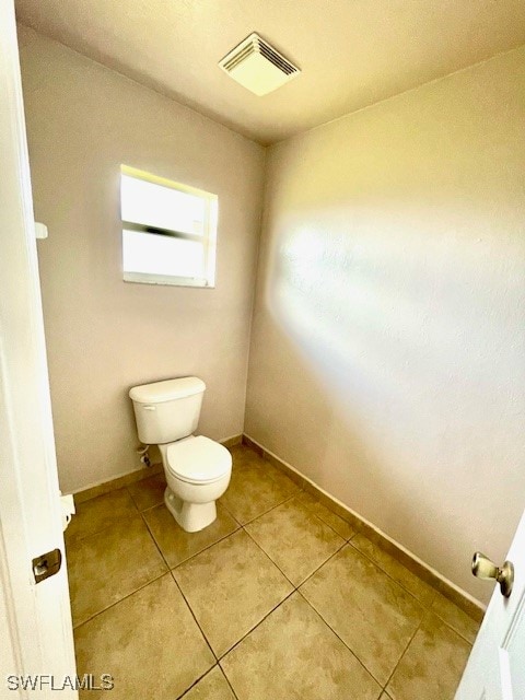 bathroom with tile patterned floors and toilet