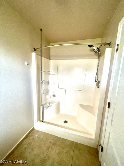 bathroom featuring a shower and tile patterned flooring