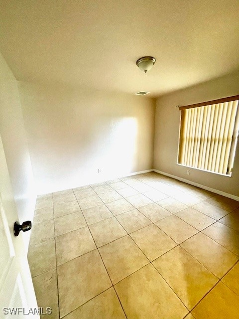 unfurnished room with light tile patterned floors