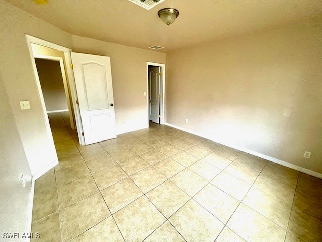 empty room with light tile patterned floors