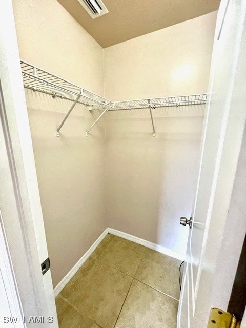 spacious closet with light tile patterned floors