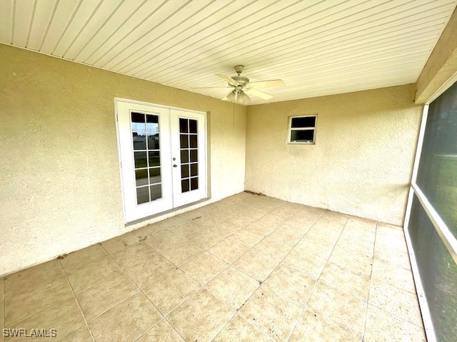 unfurnished sunroom featuring french doors and ceiling fan