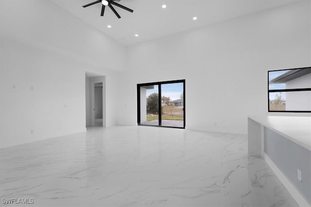 empty room with high vaulted ceiling and ceiling fan