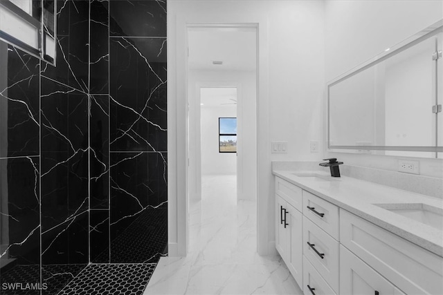 bathroom featuring vanity and tiled shower