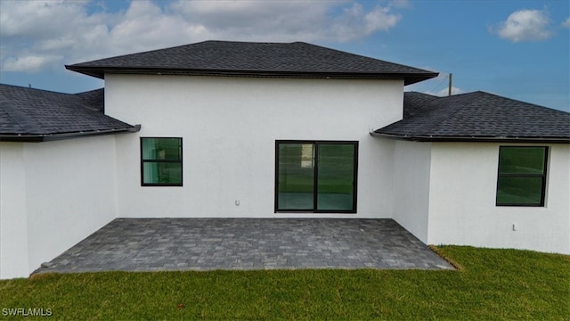 rear view of house with a yard and a patio area