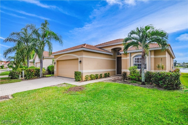 mediterranean / spanish-style house with a garage and a front yard