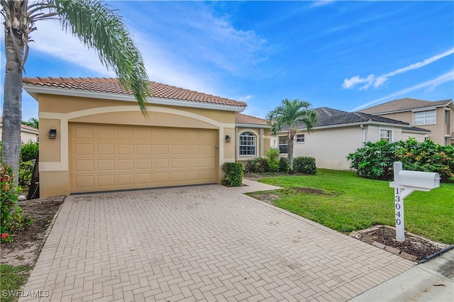 view of front facade with a front yard and a garage