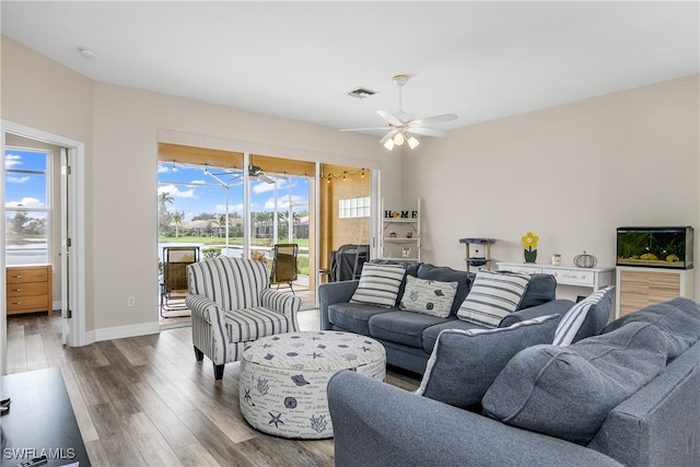 living room with wood-type flooring and ceiling fan