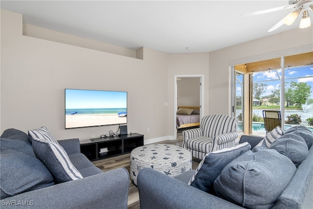 living room with wood-type flooring and ceiling fan