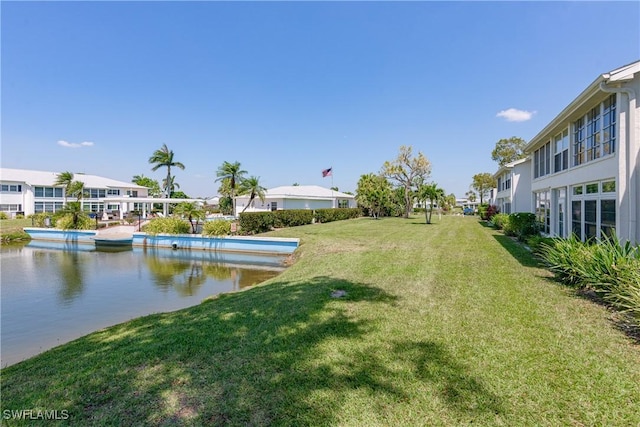 view of yard featuring a residential view and a water view