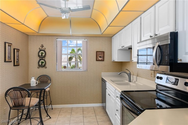 kitchen with white cabinetry, stainless steel appliances, and a sink