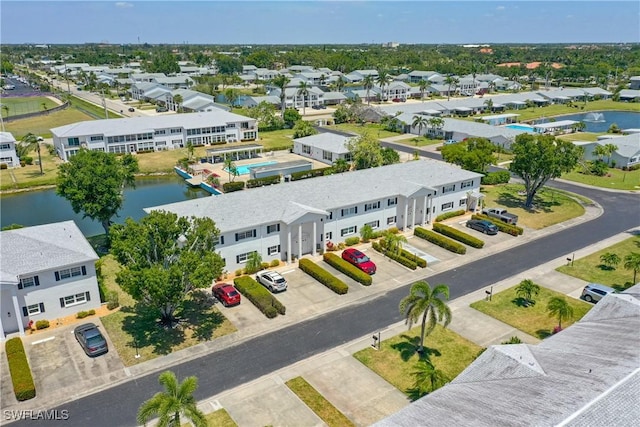 birds eye view of property with a water view and a residential view