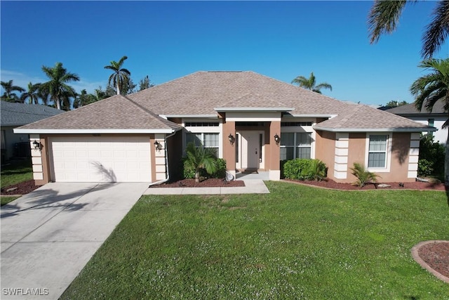 ranch-style house featuring a garage and a front lawn