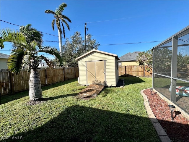 view of yard featuring glass enclosure and a storage unit