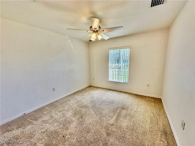 carpeted spare room with ceiling fan