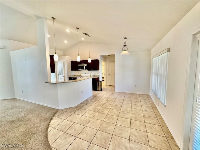 kitchen featuring vaulted ceiling, decorative light fixtures, range, light tile patterned floors, and kitchen peninsula