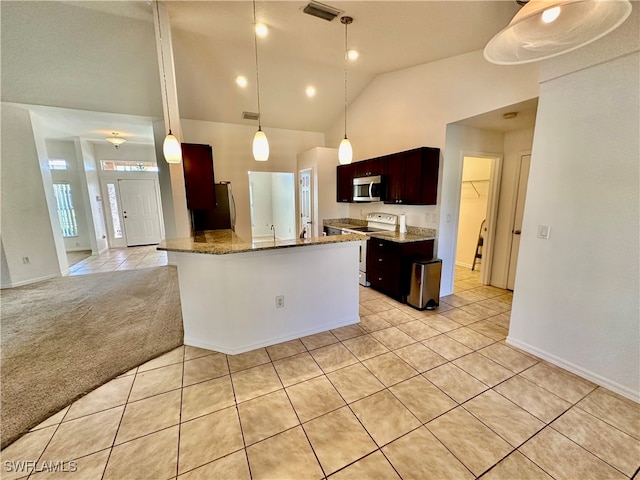 kitchen featuring pendant lighting, light tile patterned floors, sink, appliances with stainless steel finishes, and dark stone counters