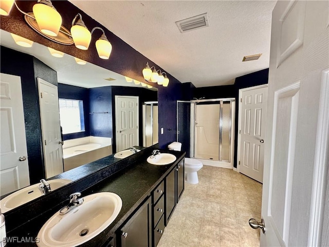 full bathroom with independent shower and bath, vanity, a textured ceiling, and toilet