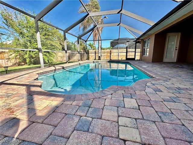 view of swimming pool featuring a lanai and a patio